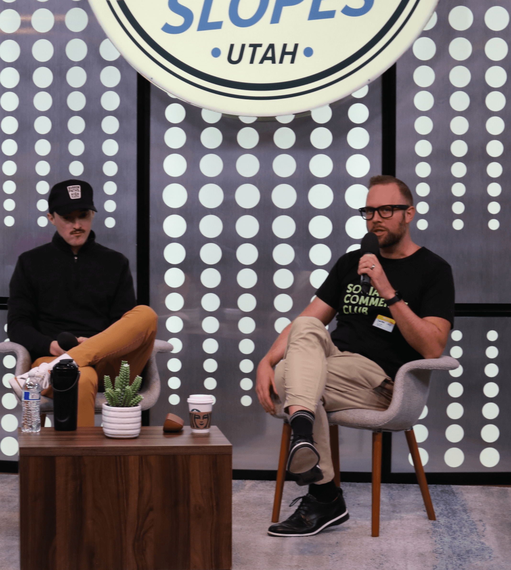 Jordan West speaking at an industry event in a Social Commerce Club shirt